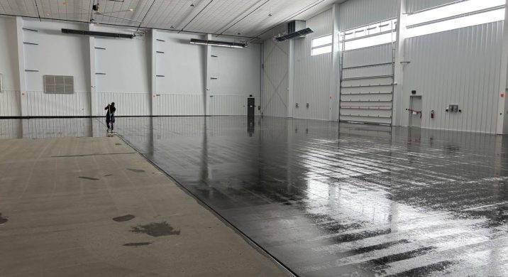Industrial hangar floor coating in progress at Perkins Hangar, Wright-Patterson Air Force Base